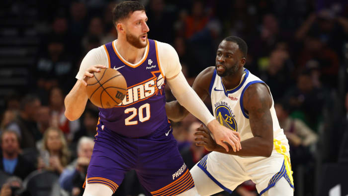 Golden State Warriors forward Draymond Green defends against Phoenix Suns center Jusuf Nurkic.